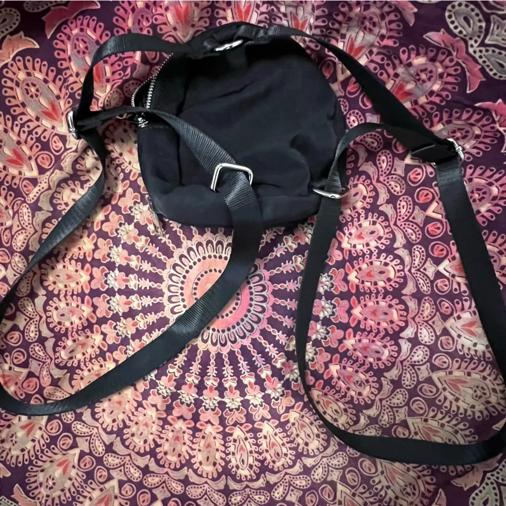 Dolls Kill • Logo Black Mini Backpack with silver exposed zipper, adjustable